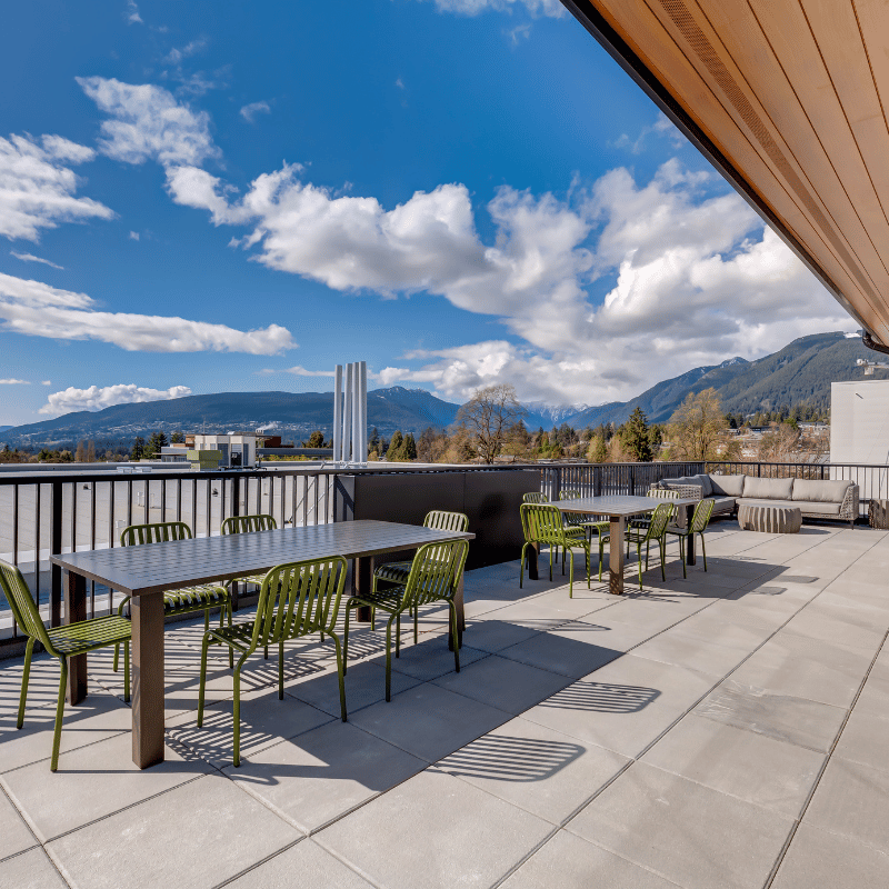 Rooftop patio with mountains in the background.